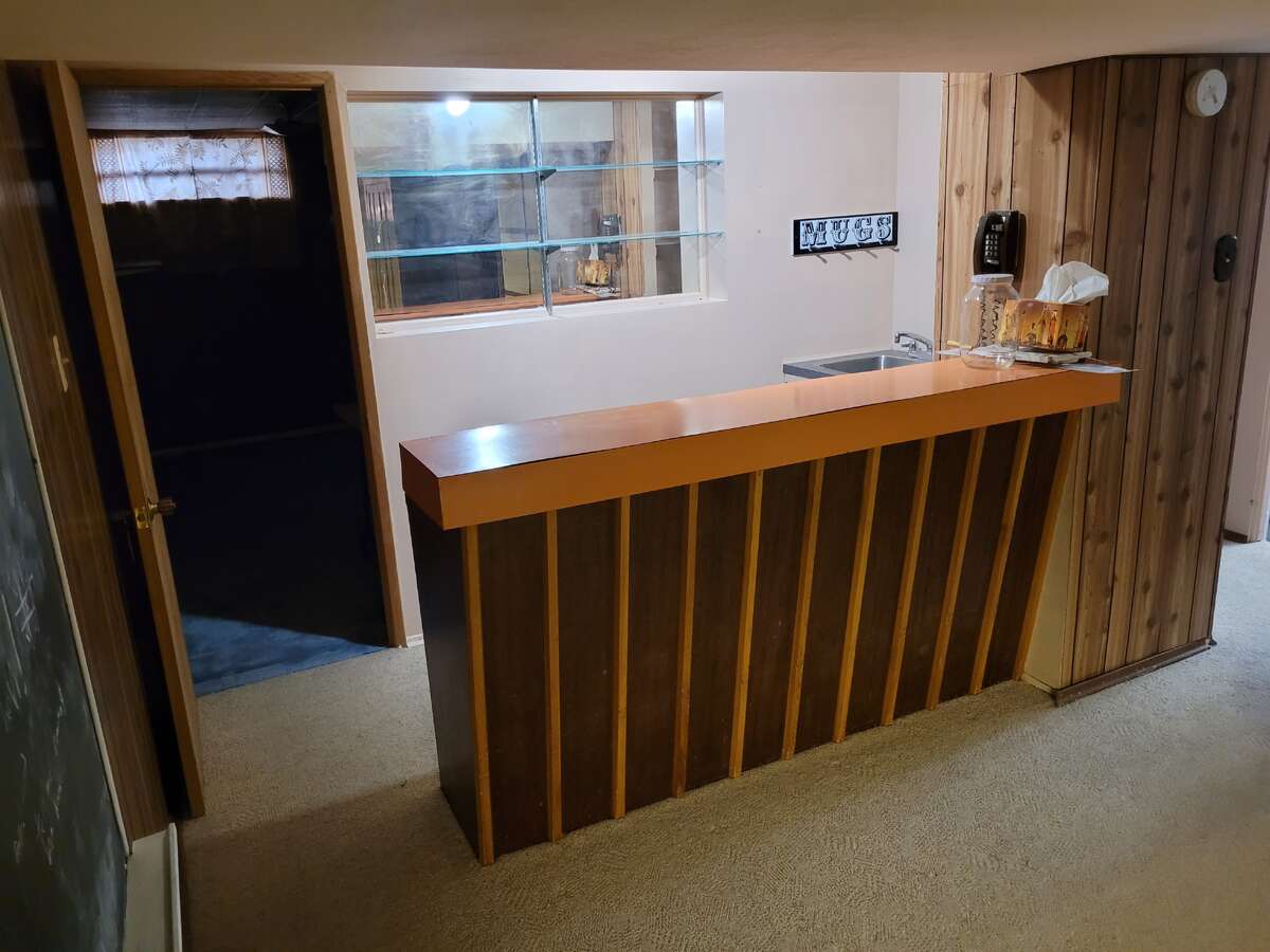 Full wet bar with floating glass shelfing