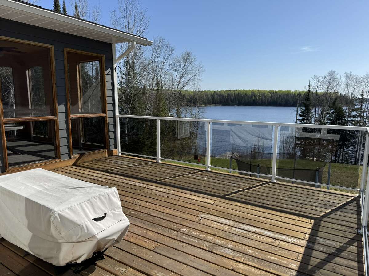 Beautiful view of Pelican Lake from the elevated deck accessed from the screened in porch