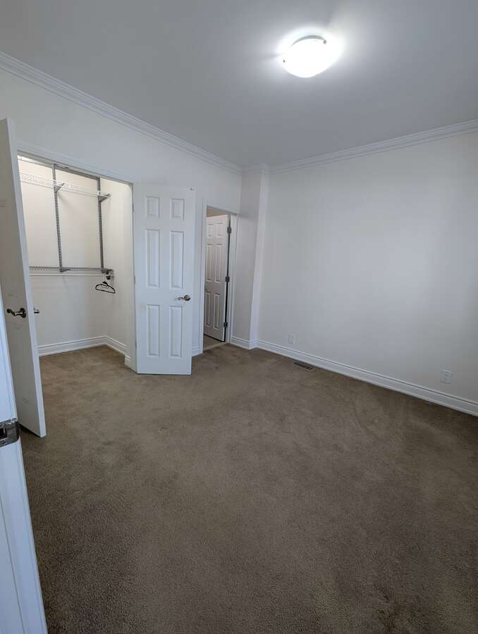 Main Floor Bedroom Overlooking Closet and Ensuite Bathroom