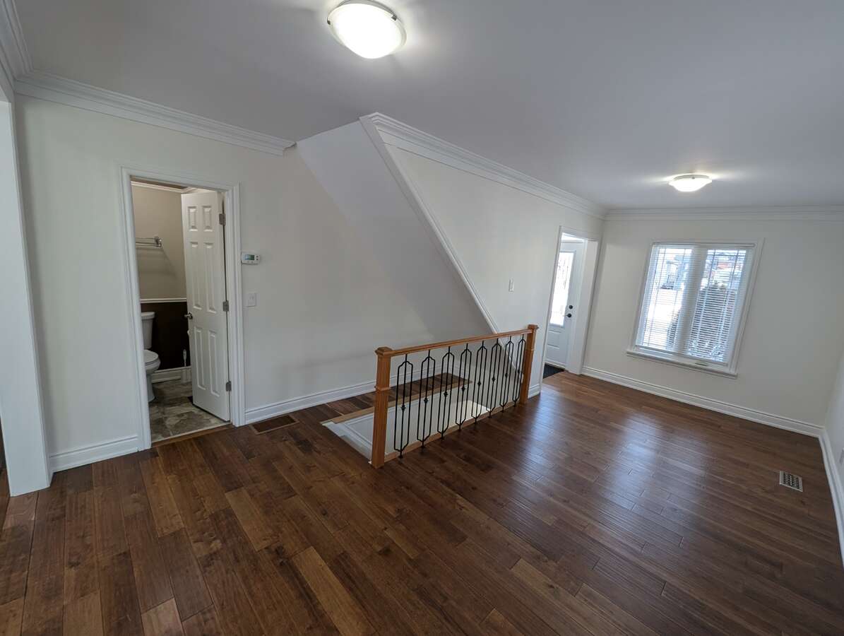 Living Room Overlooking 2pc Powder Room and Stairs to Basement