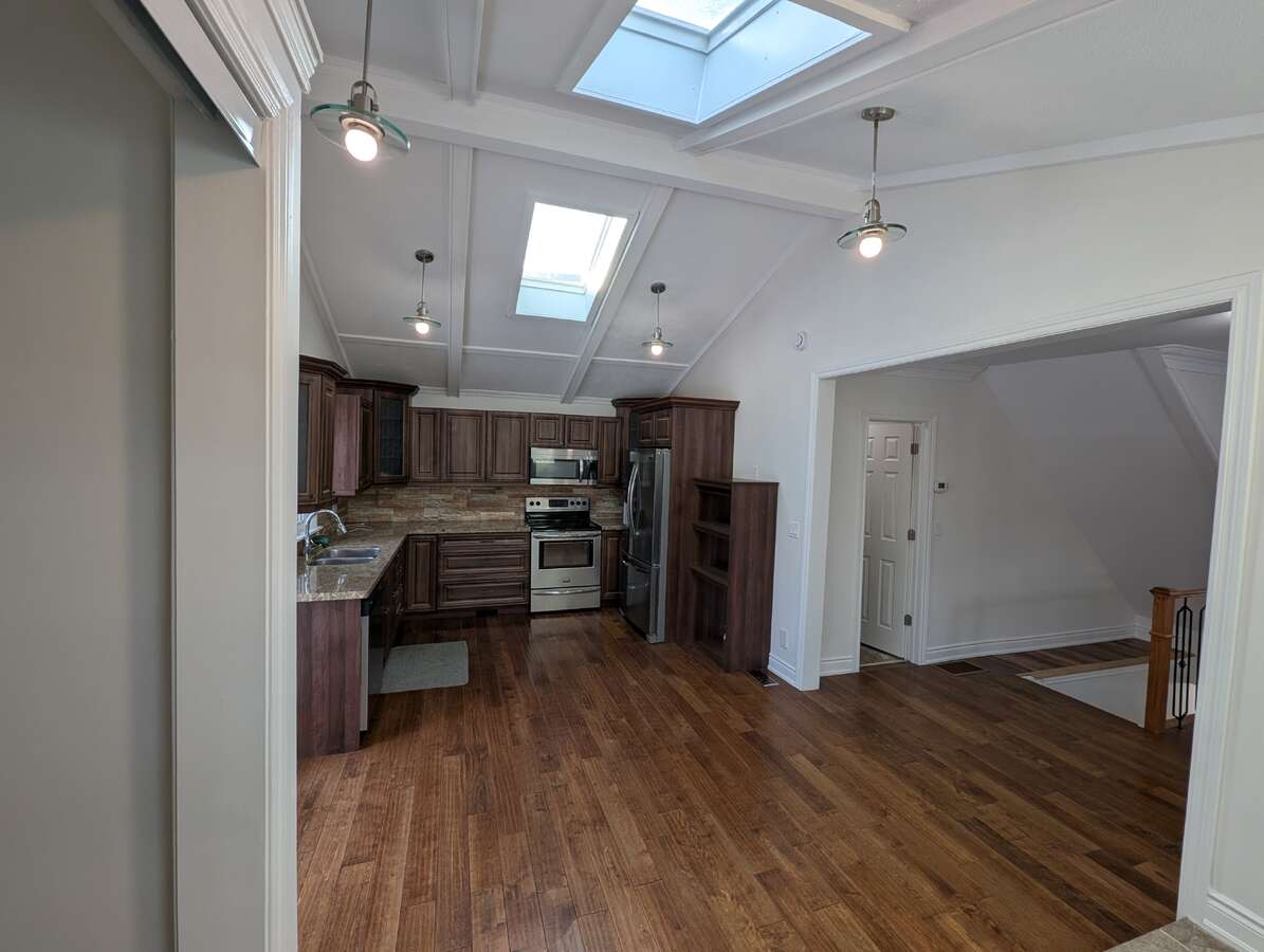 Kitchen with Powder Room Door and Stairs leading to Basement