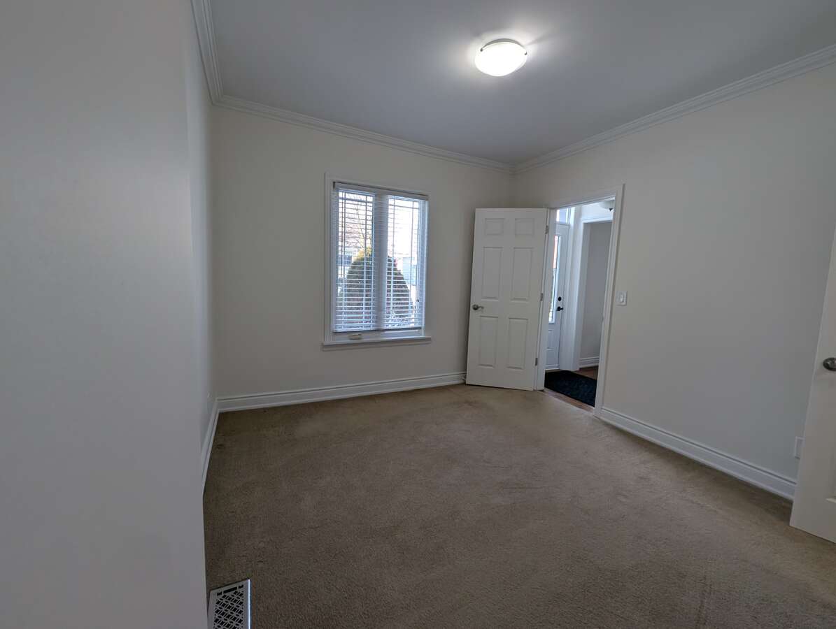 Main Floor Bedroom Overlooking Front Entrance