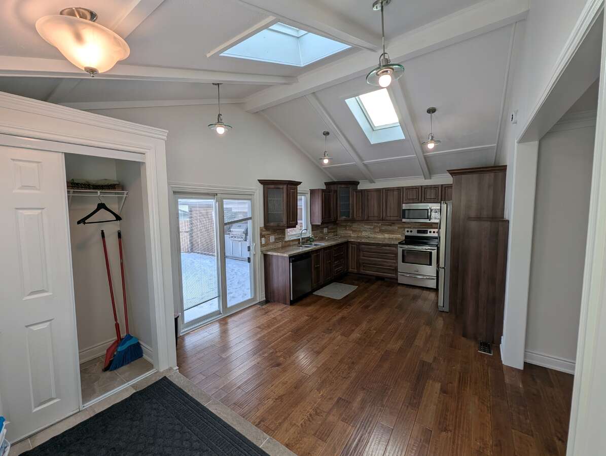 Kitchen with Sliding Door Leading to Deck and Outdoor Kitchen