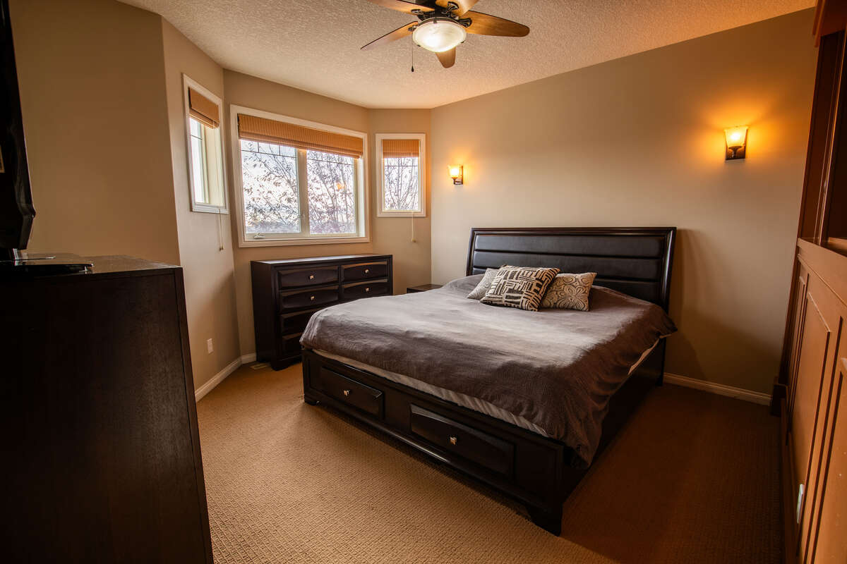 Large primary bedroom with luxurious ensuite, walk in closet and built in storage