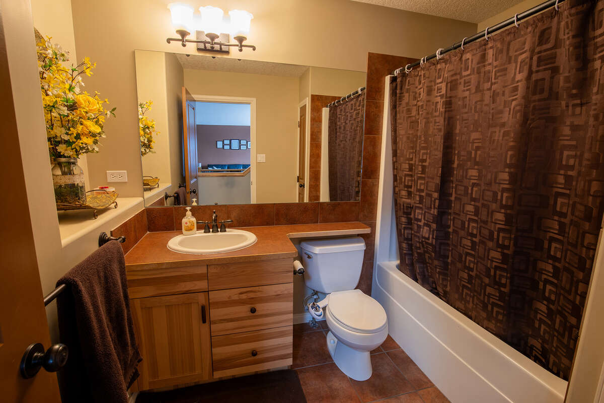 Main floor full bathroom with tub and shower