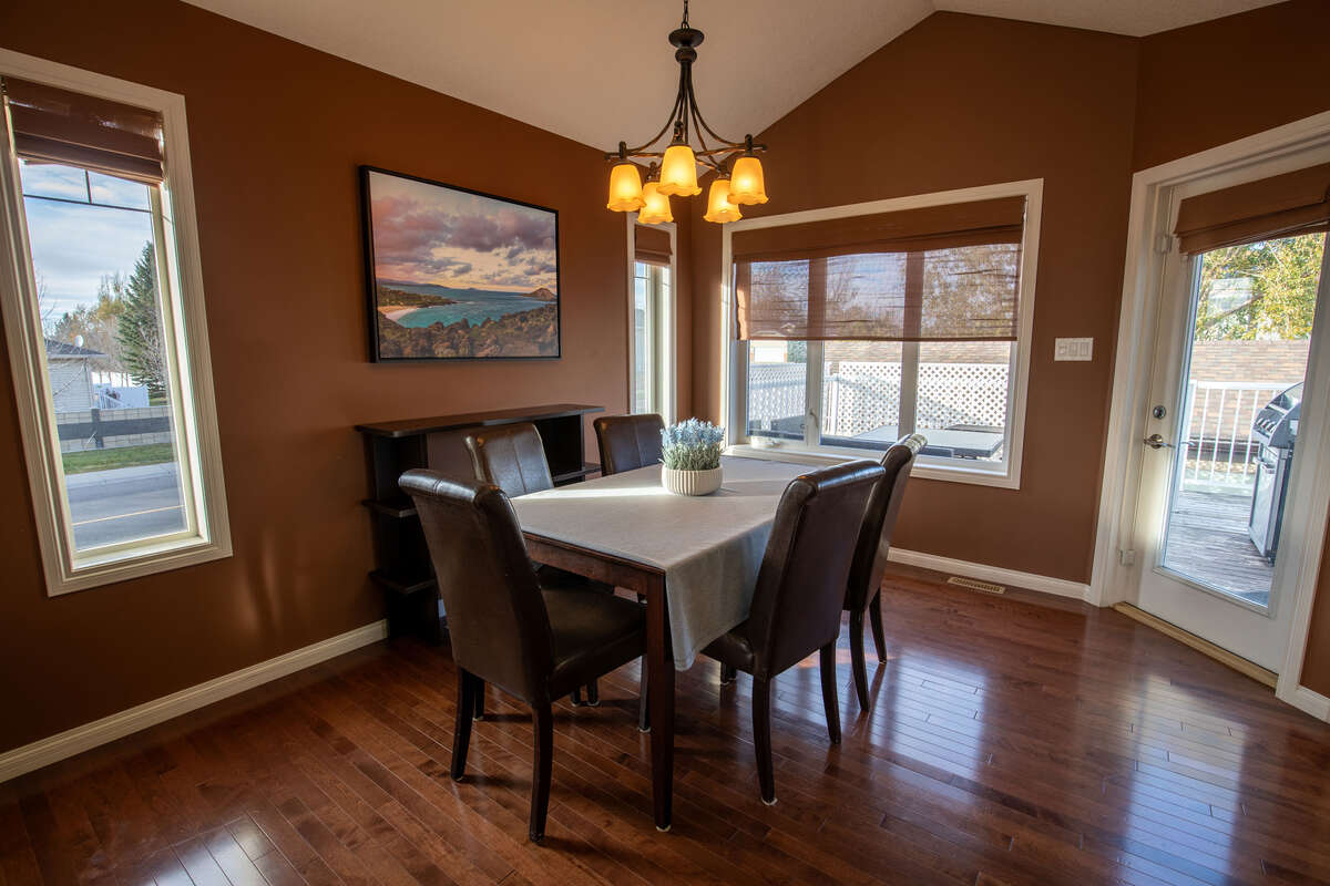 Bright dining area with access to raised deck and back yard