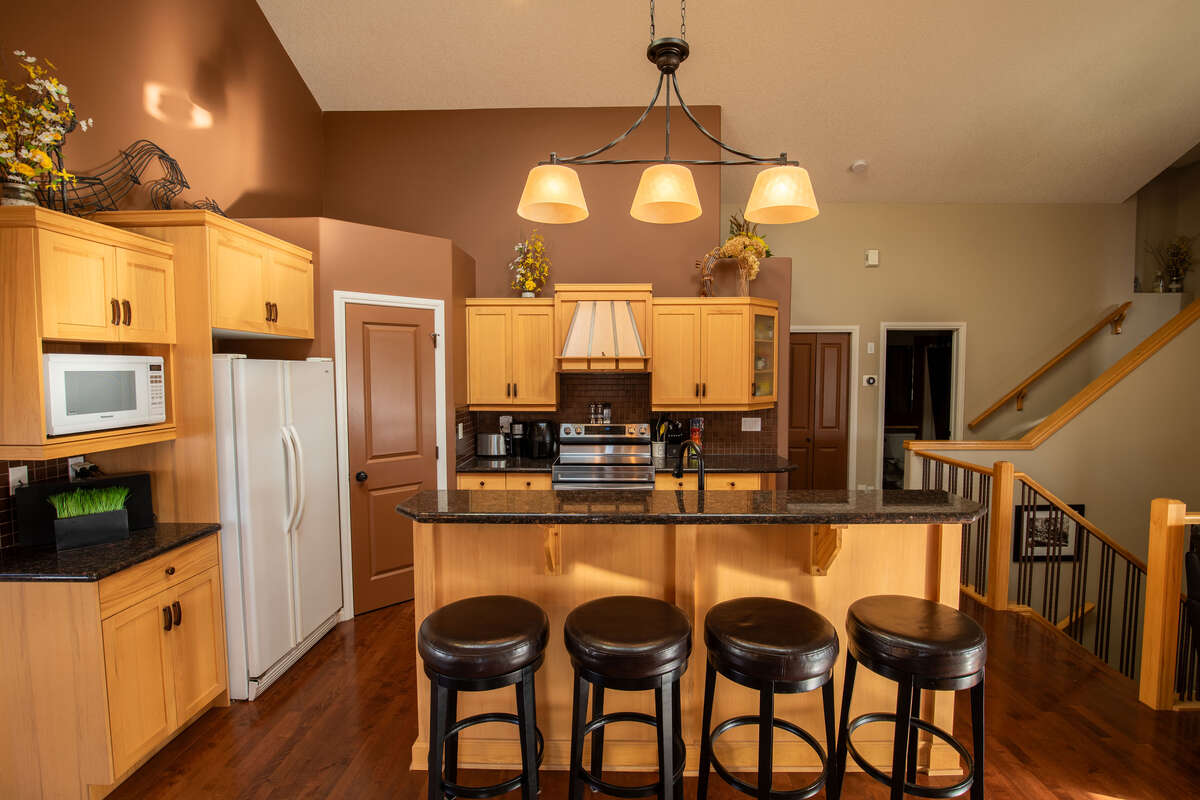 Large kitchen with two skylights, granite counter tops, pantry and new range