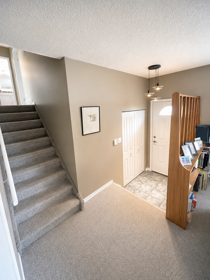Front entrance showing staircase leading to the upper level of the house (to three bedrooms)