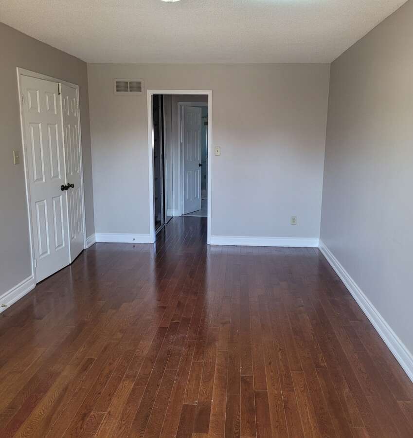 Master bedroom with beautiful hardwood flooring, walk in closet