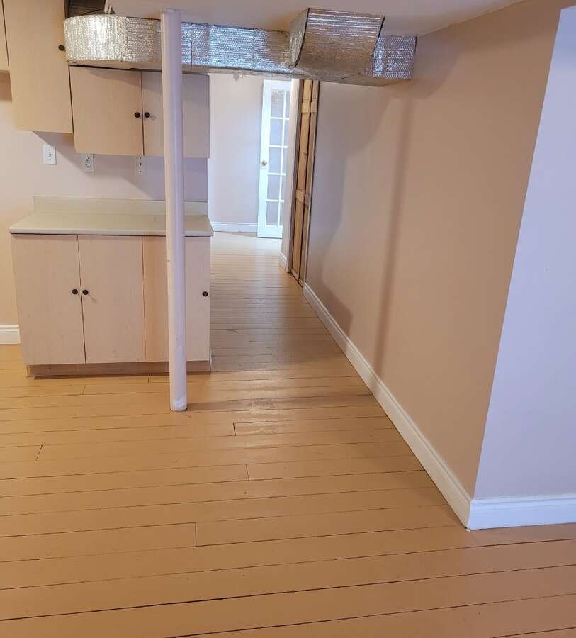 Basement Unit living area with walkout to backyard, pine floors thru out