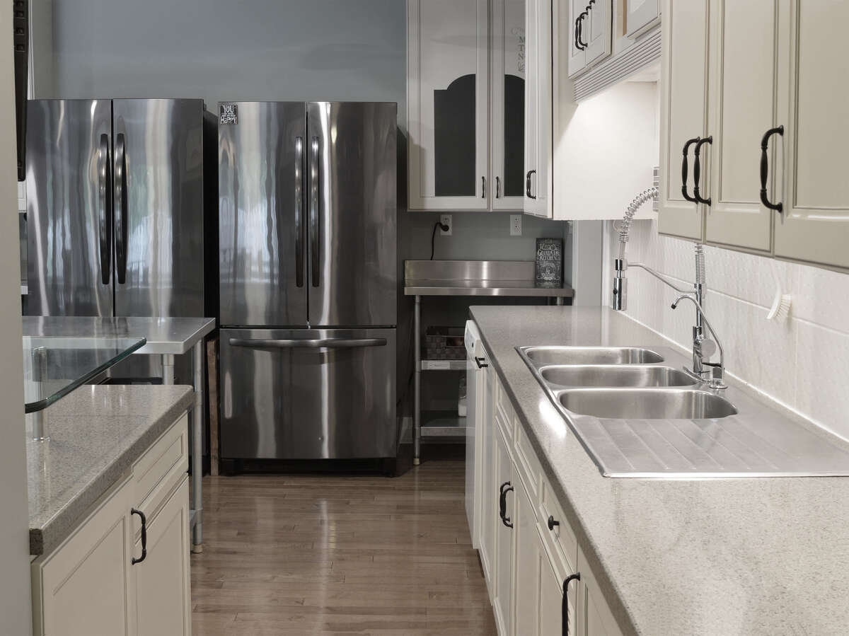 Spacious kitchen with ample cabinetry and sleek countertops, ideal for culinary enthusiasts.