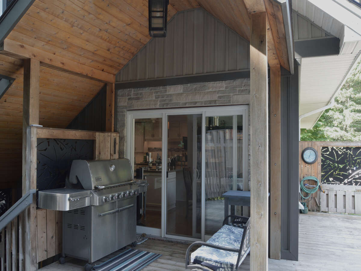 Covered portico off of the kitchen for barbequing in any weather.