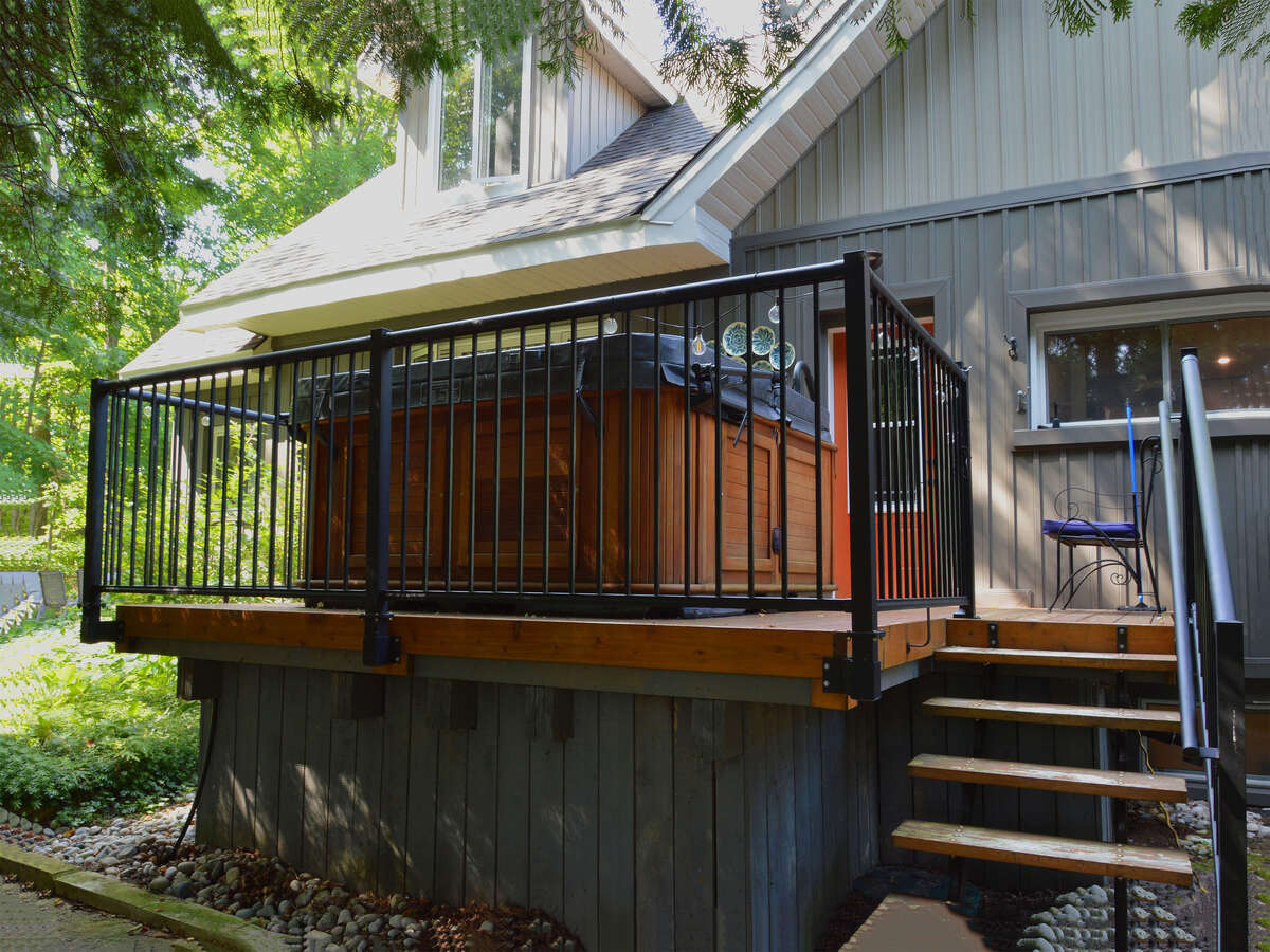 Private hot tub deck perfect for unwinding with back door leading to the bedrooms for easy access..