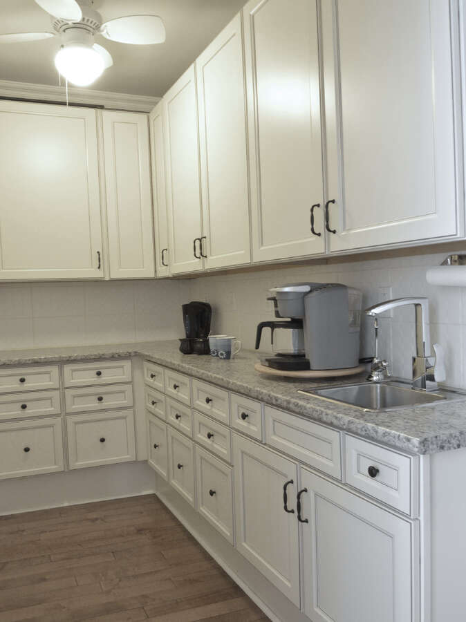 Dedicated coffee area and servery with ample storage, perfect for morning routines.