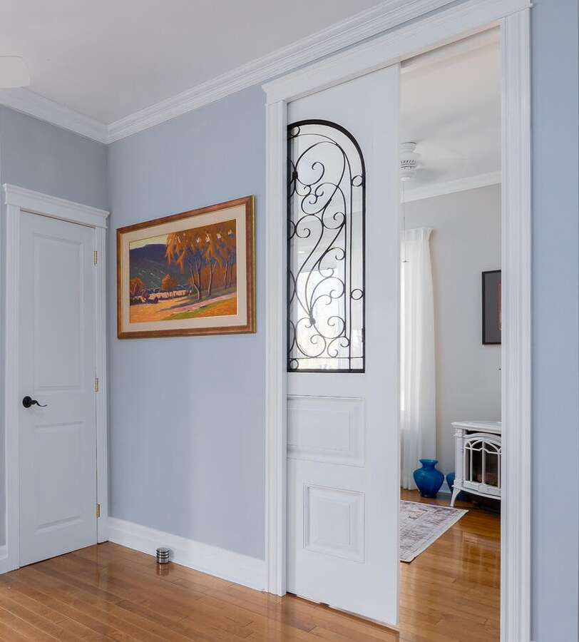 Nine foot glass and metal pocket office door for privacy, revealing corner cozy fireplace.
