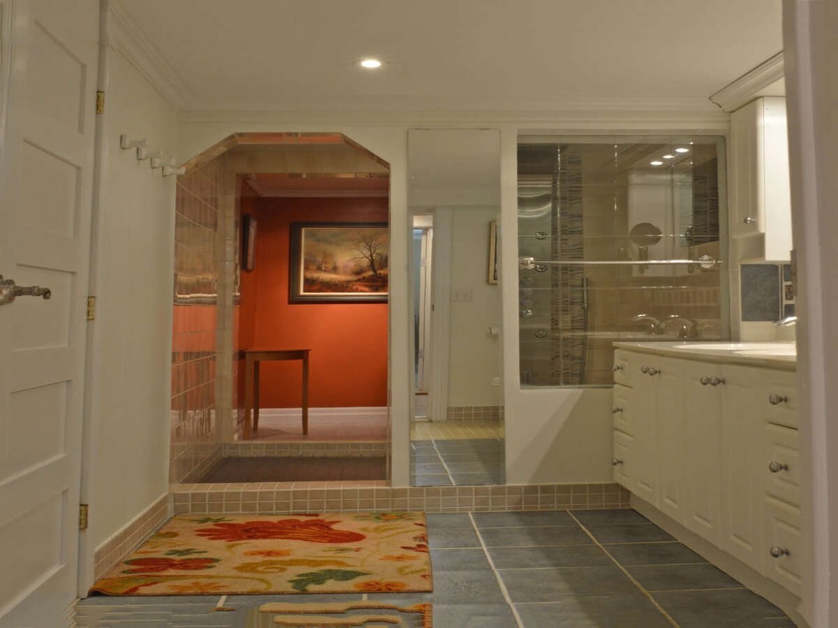Spacious bathroom with a step-through to an infrared sauna, perfect for relaxation.