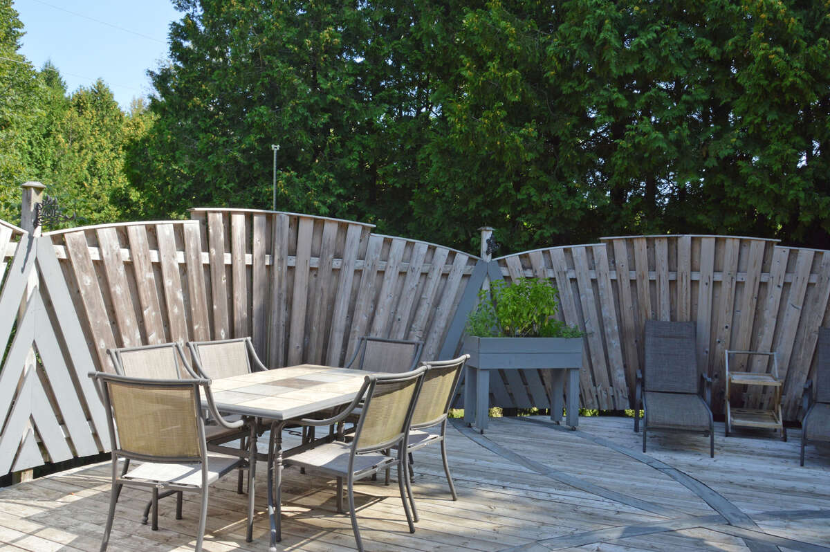 Expansive deck perfect for outdoor dining and lounging, surrounded by privacy fencing.