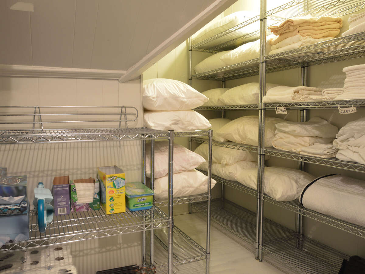 Expansive linen closet in the upstairs hallway, offering ample storage and easy accessibility.