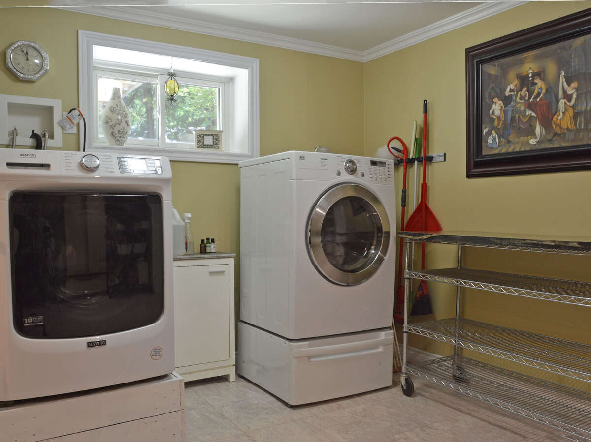Laundry room with large capacity washer and dryer and convenient folding area.