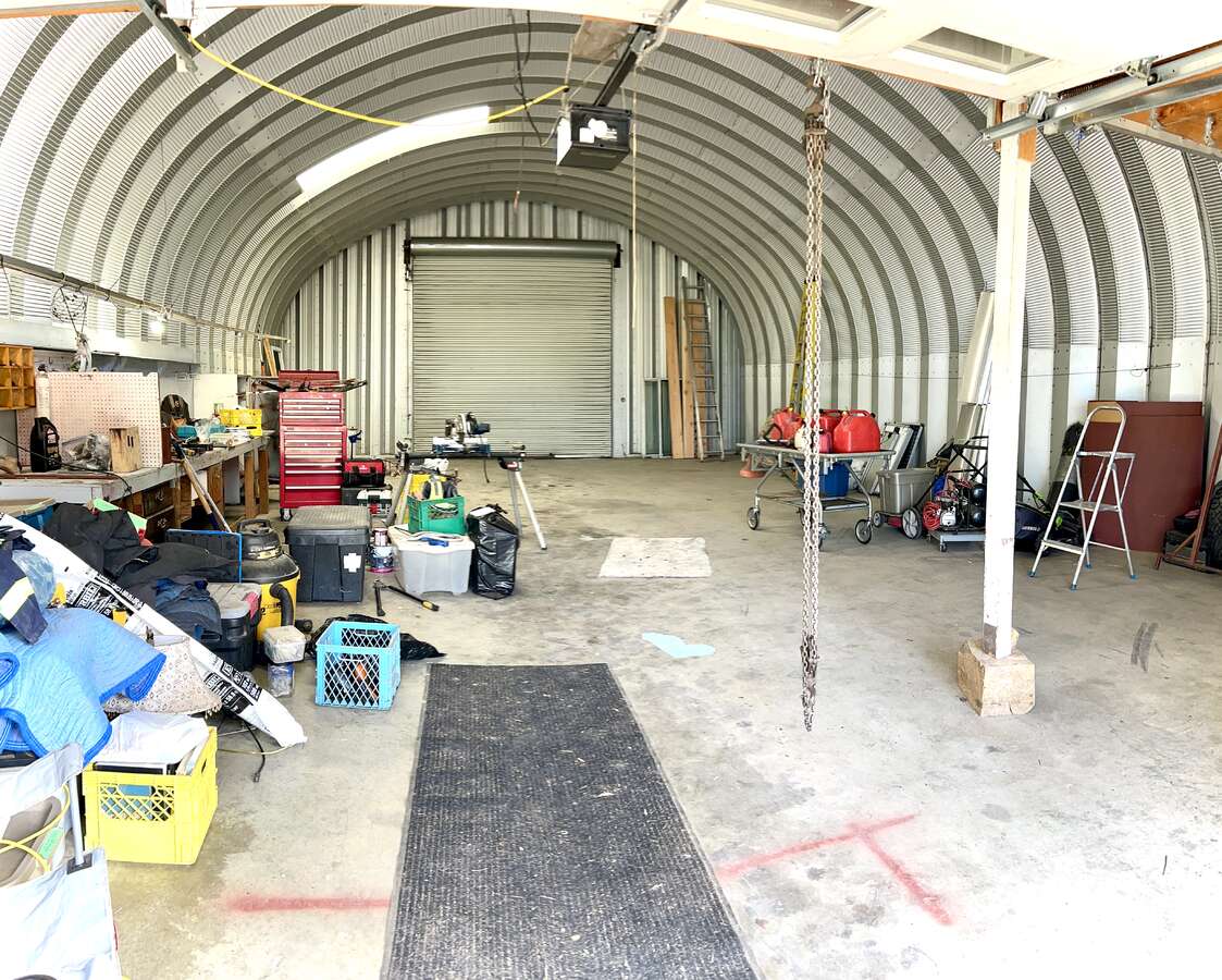 Floor heat lines installed and six inches polished cement floor. The rear rolling door is twelve by twelve feet.
