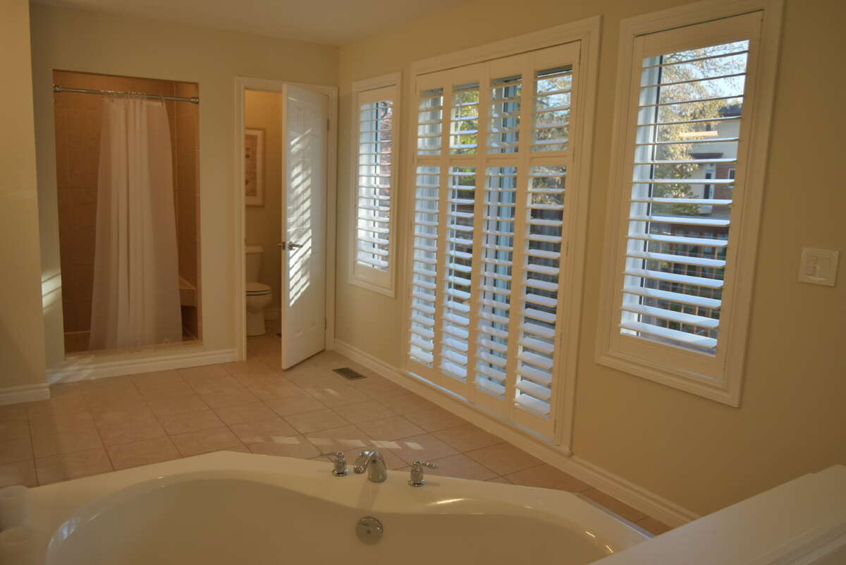 Primary ensuite bathroom, door to balcony