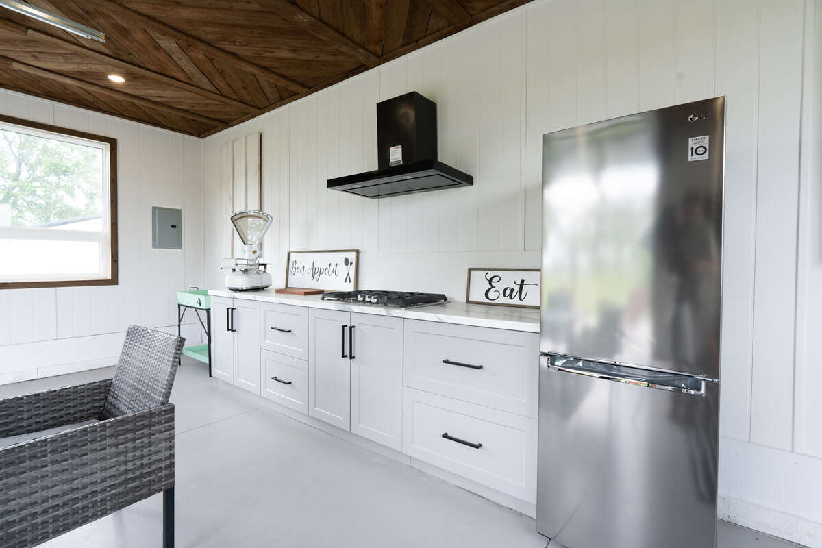 Entertainer’s cabana with kitchenette, working fridge and gas stove, furniture seen is included