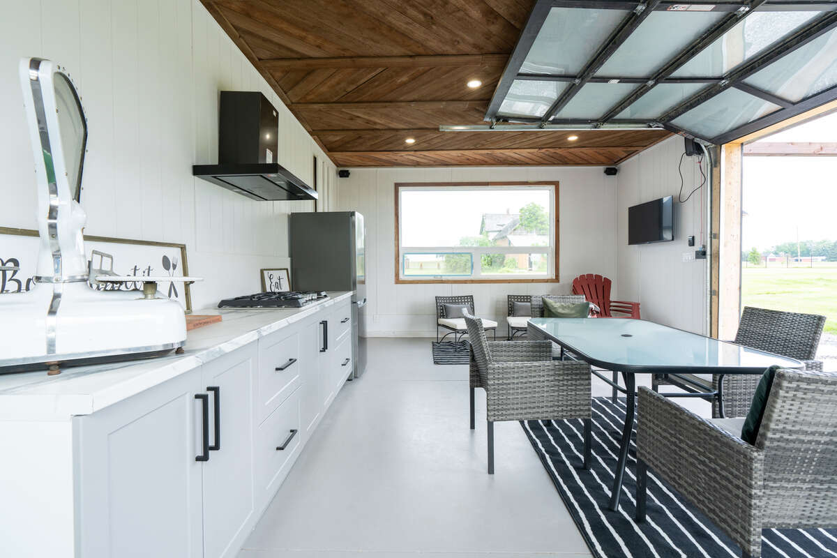 Cabana with herringbone wood ceilings and lots of light, cabinetry and concrete floors