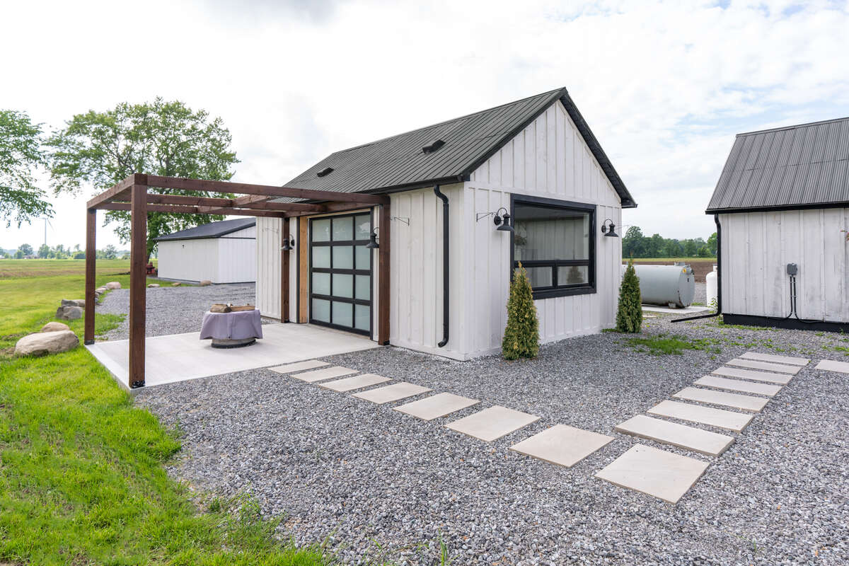 Entertainer’s cabana with kitchenette and outdoor deck with trellis for patio string lights