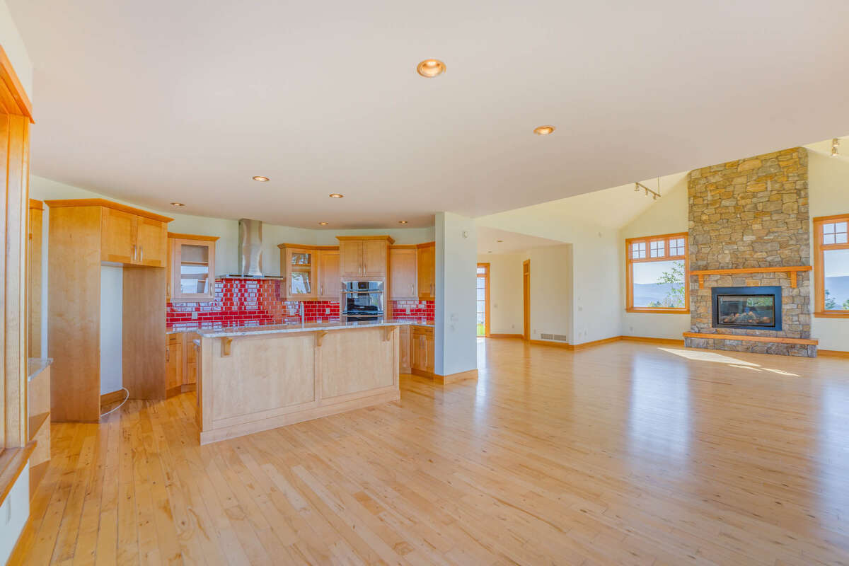 Spacious open living area with vaulted ceiling and real stone fireplace