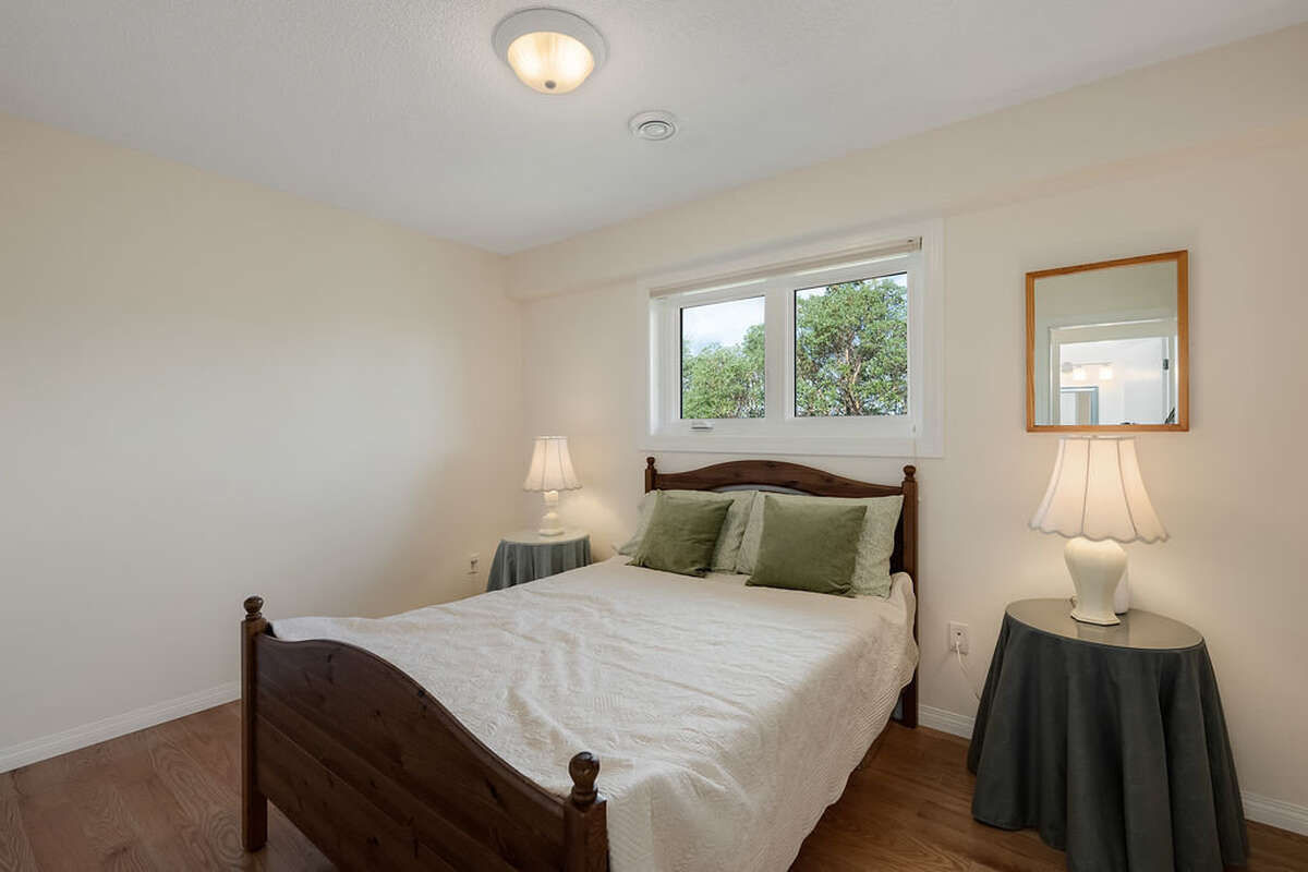 Third bedroom with a large closet with custom fitted organizers to match the flooring