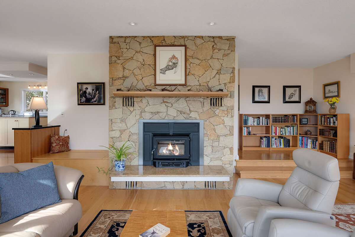 Living room, solid oak flooring, and Jotul fireplace - the granite hearth matches the kitchen island