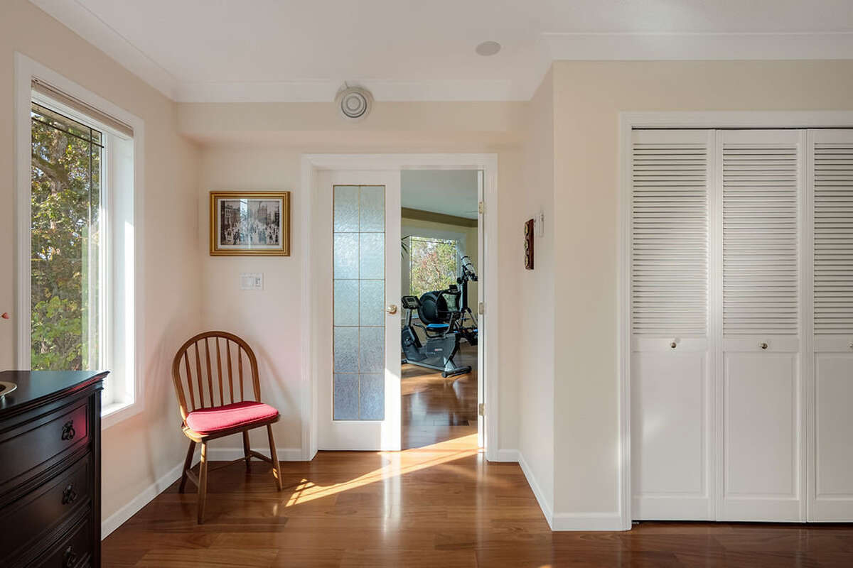 The entrance hall has French doors opening to fitness/sun room - the glass matches the stair rails