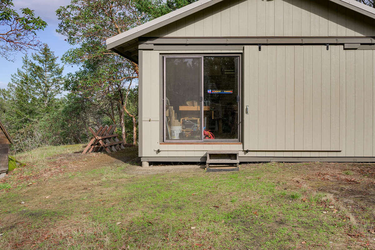 Studio/workshop, currently used as a woodworking shop, has 120/240 V power, a window and skylight