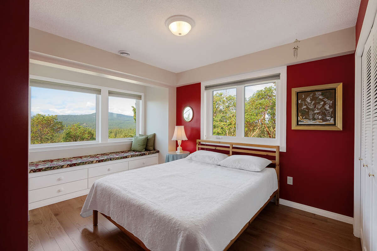 Second bedroom with windows on two sides and a large closet with custom fitted organizers