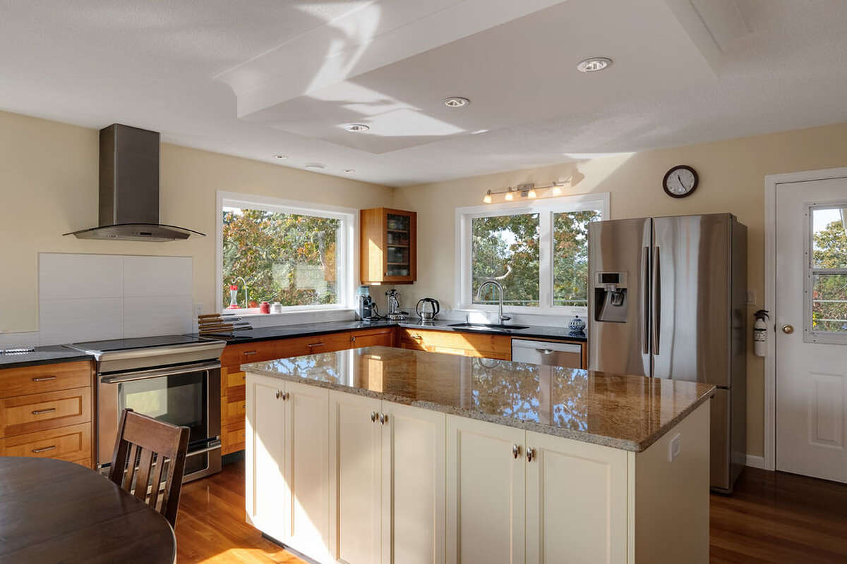 Kitchen with cherry cabinets by South Island Woodwork, granite countertops, and stainless appliances