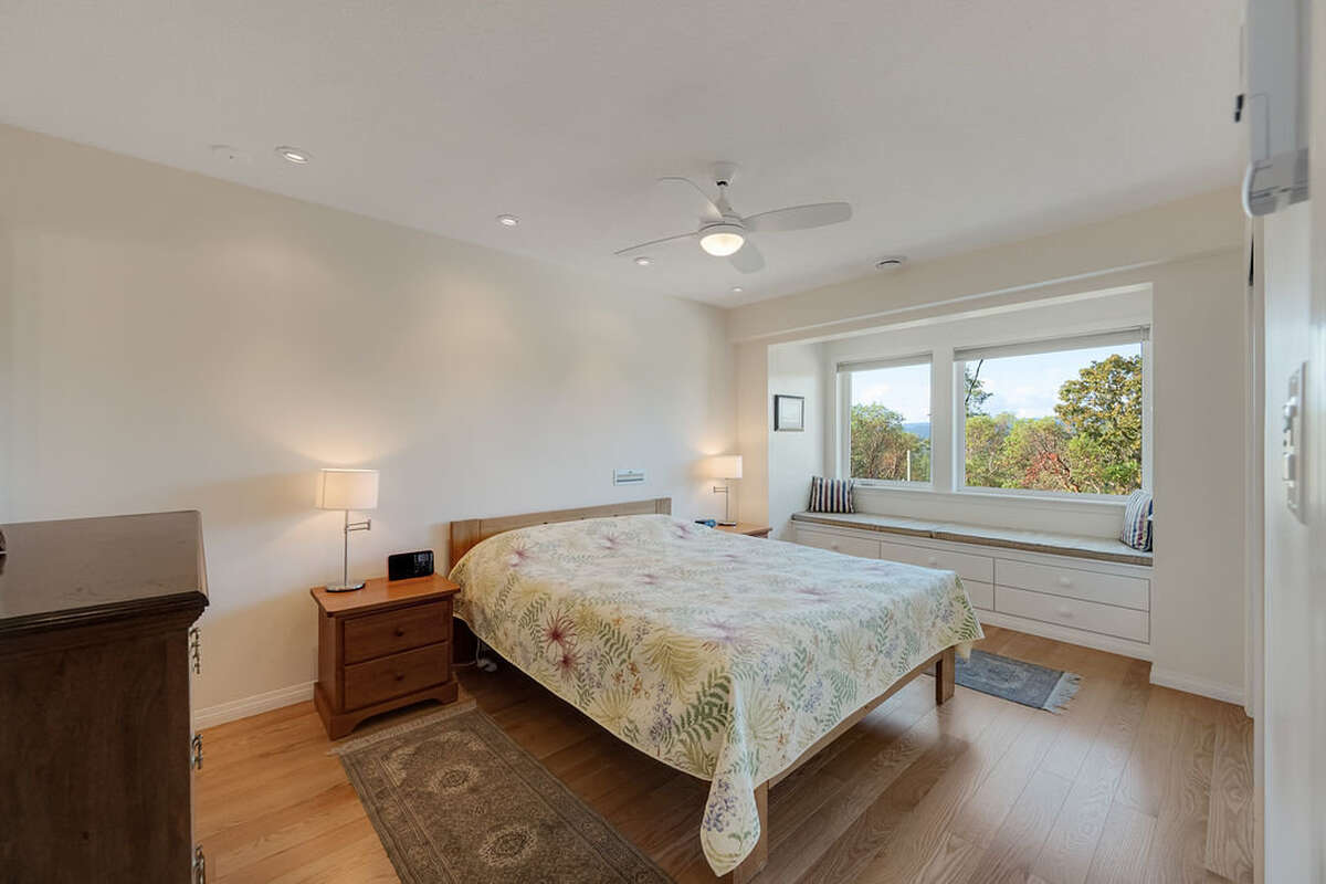 Main bedroom with window seat a large closet with custom fitted organizers that match the flooring