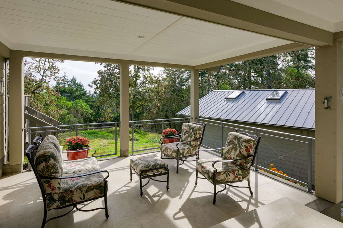 The terrace outside the front door may be enclosed as a screened porch in summer
