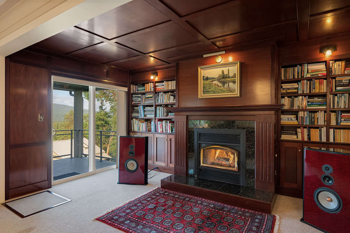 Air-tight fireplace, mahogany paneling, mantel, cupboards, and book shelves (crawlspace below)