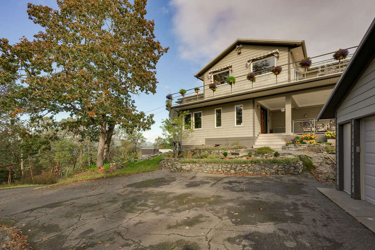 The house from outside the double garage, which has 120/240 V power, windows, skylights, & 16' door
