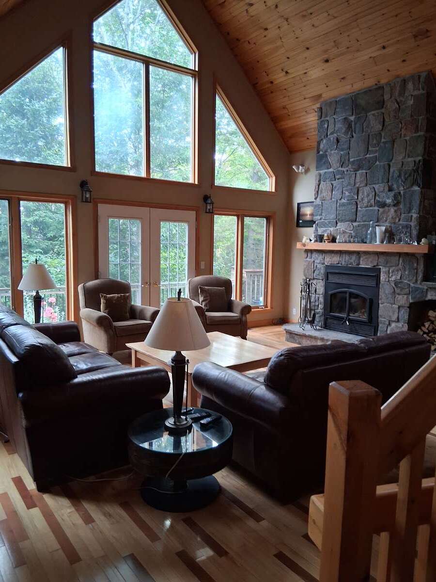 Sunlight is all around and the granite fireplace warms everyone up..