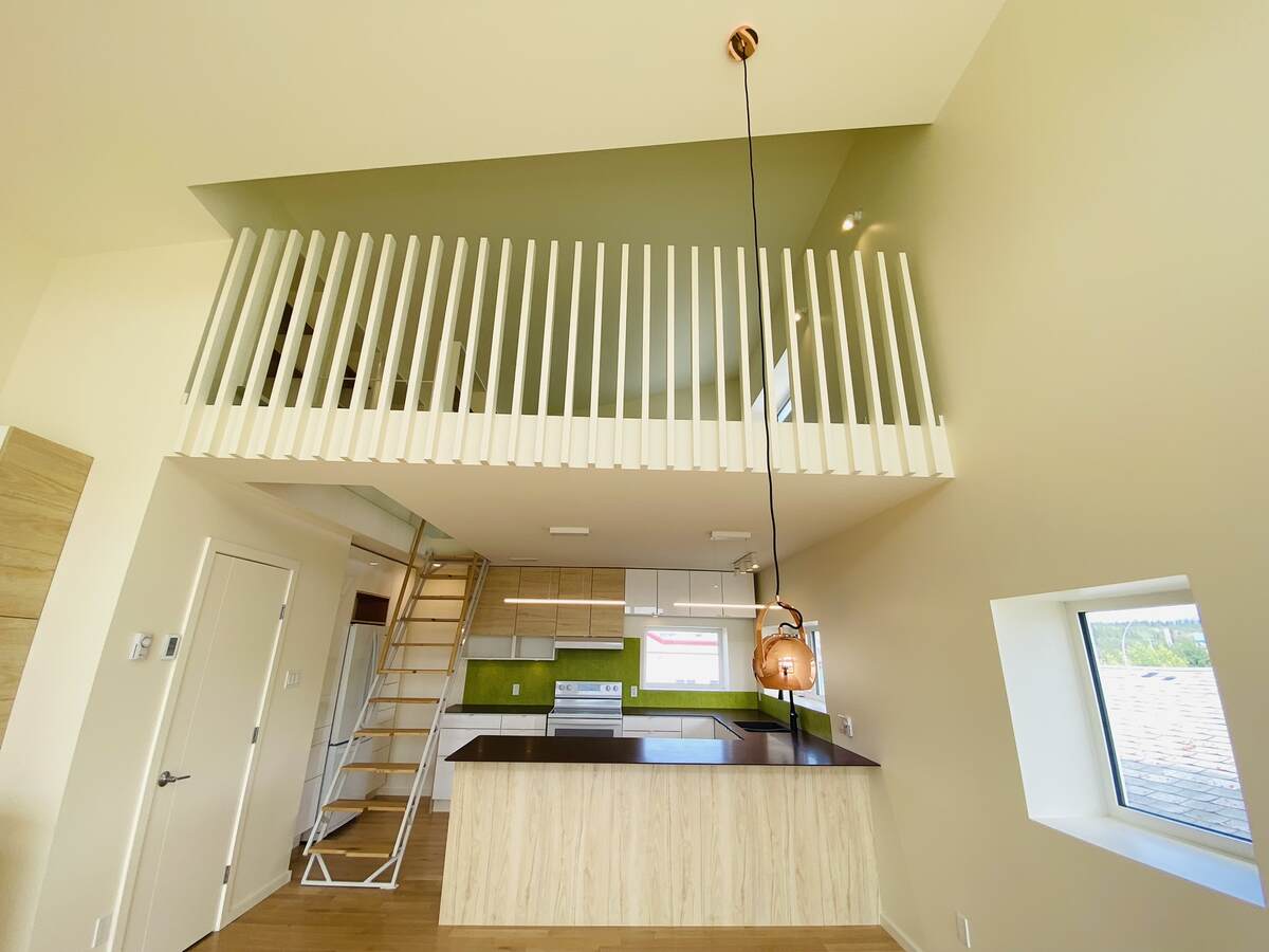 Kitchen, stairs to the loft,  2-pc bathroom.