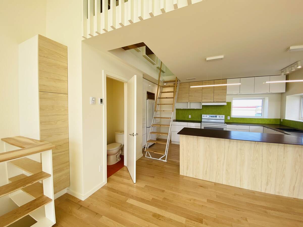 Kitchen, stairs to the loft,  2-pc bathroom.