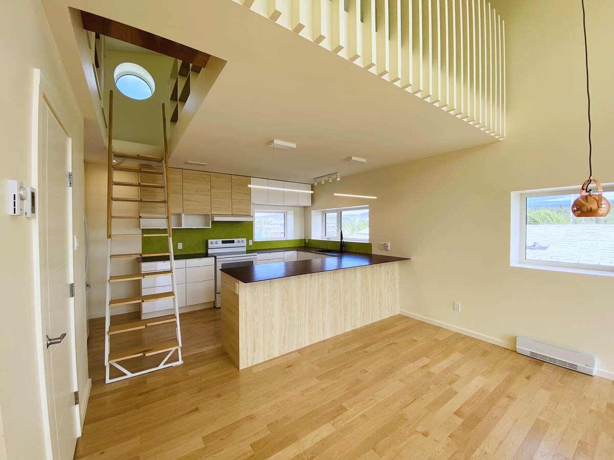 Kitchen, stairs to the loft,  2-pc bathroom.