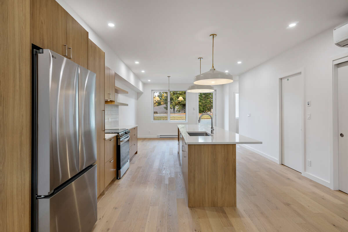 Own your own strata free townhome with backyard