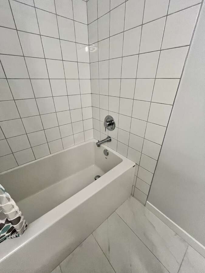 New deep soaker tub with new fixtures and tile.