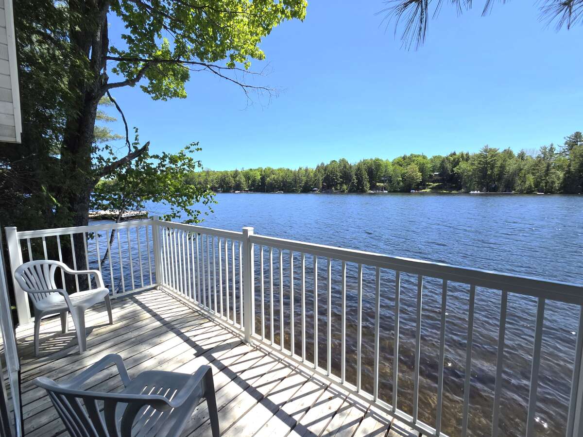 Bunkie deck hangs over lake