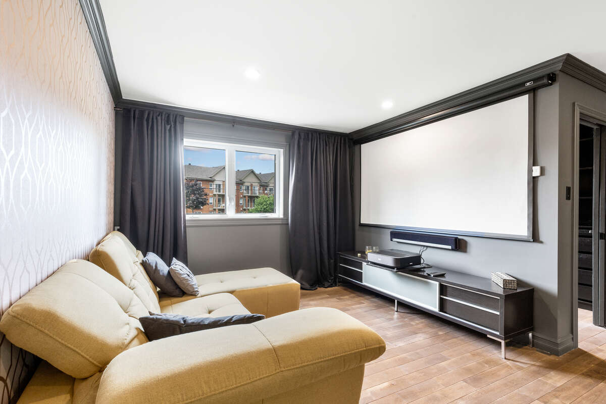 “Luxury Primary Bedroom – Bright, Spacious, and Inviting”including a built-in home theater system