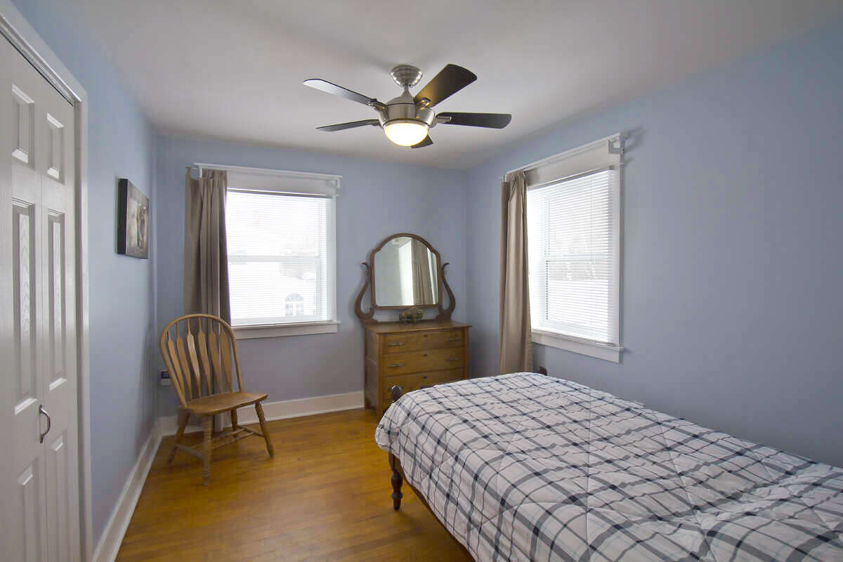 Comfortable upstairs bedroom with good natural light.