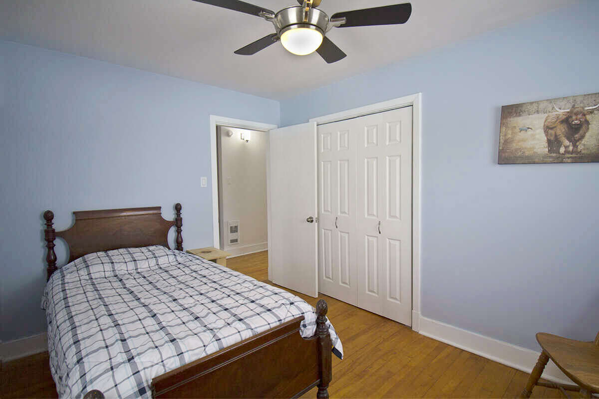 Comfortable upstairs bedroom with good natural light.