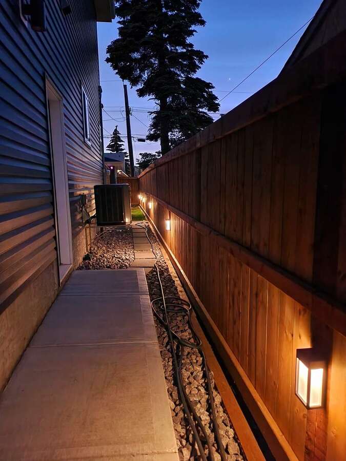 side entrance w/ Trane Air Conditioner with / 8yrs warranty remaining . Also the custom built fence